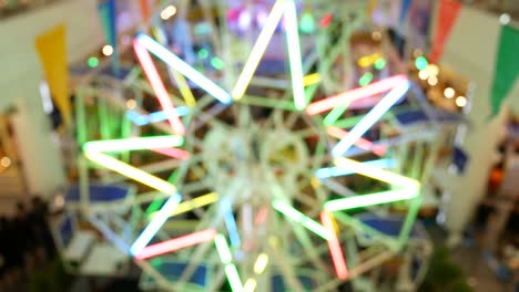 abstract blur background : moving ferris wheel decorated with colorful fluorescent lamps.