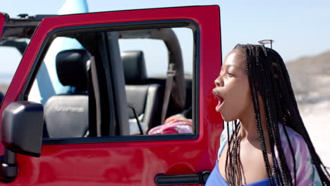 Una-Joven-Afroamericana-Disfruta-De-Un-Día-Soleado-En-La-Playa-En-Un-Viaje-Por-Carretera