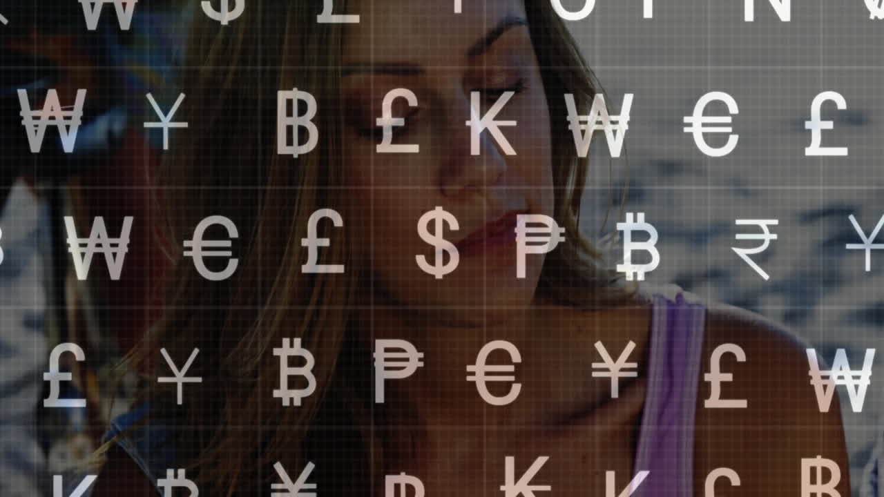 Animation of currency symbols overlaying woman working at home on financial tasks