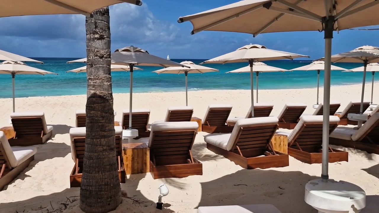 Beach on Caribbean Sea and St. Maarten Island, Sunbeds and Parasols of Luxury Resort