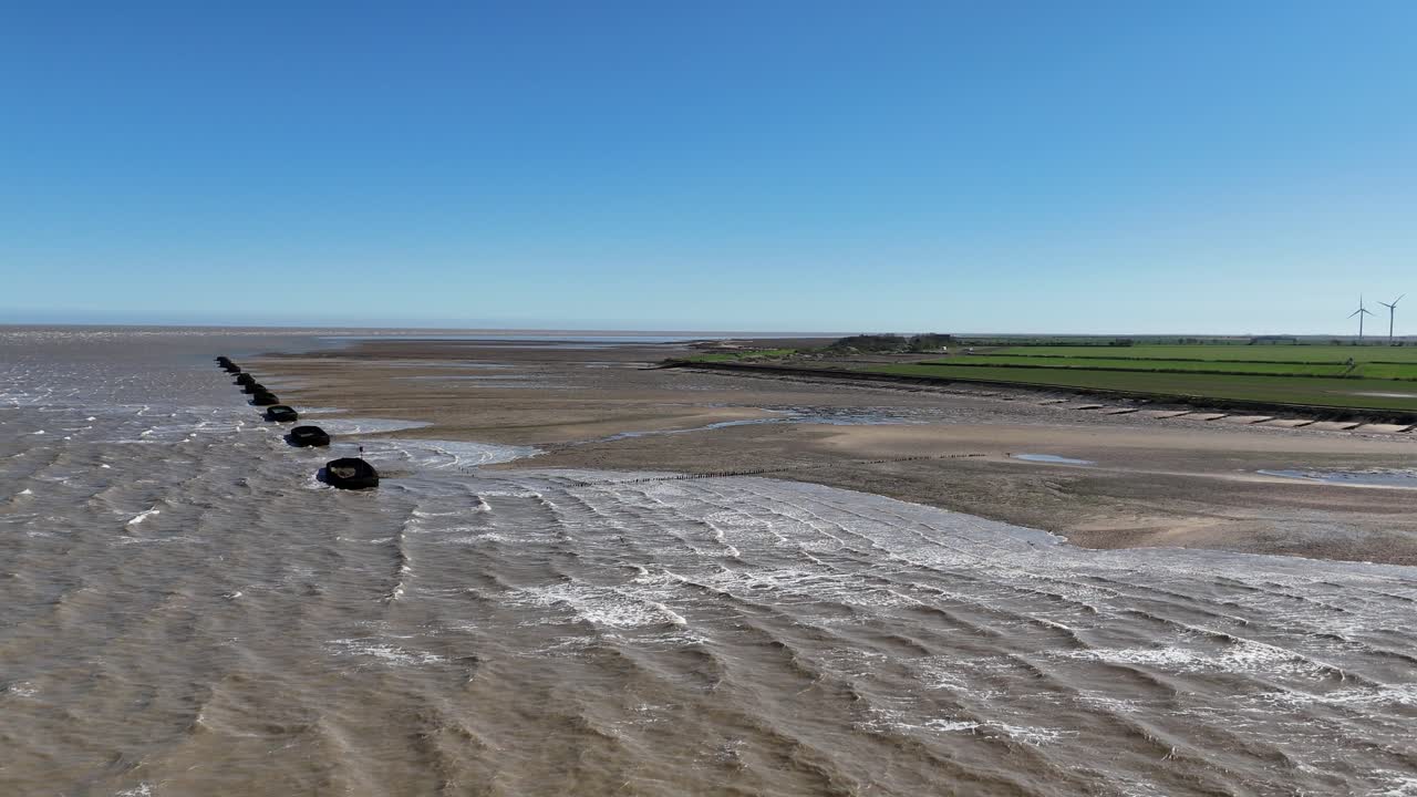 Row of Barges on River Blackwater Essex UK used for WW2 target practice