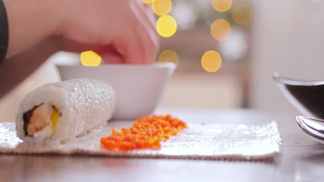 Making-Sushi-at-Home-Kitchen.-Woman-hands-rolling-homemade-sushi.