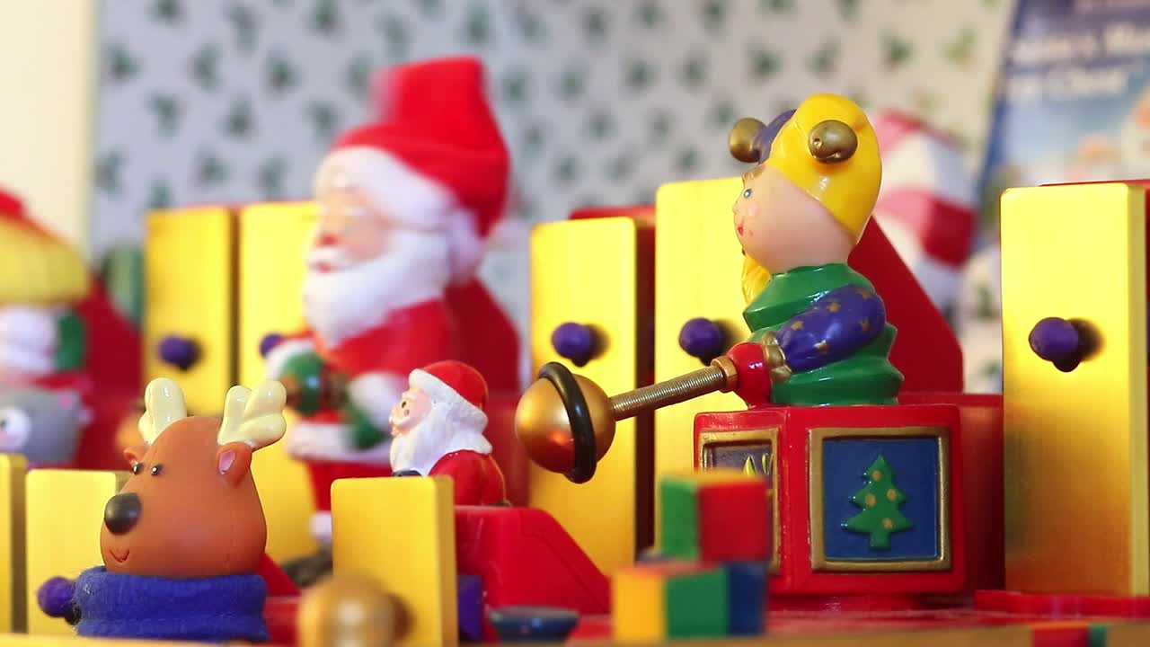 Dorking, England - August 07 2018: Christmas musical box showing Santa Claus and his helpers playing tunes on a toy xylophone. Close up of Santa Claus toy.