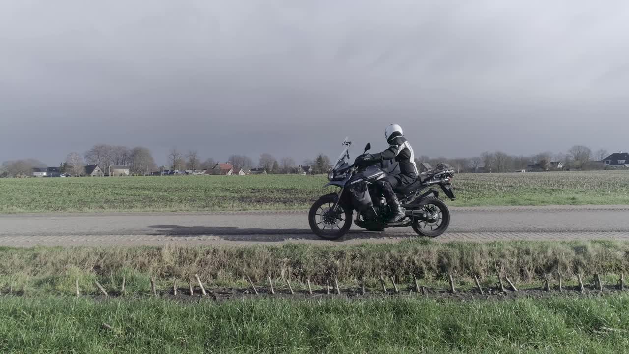 Drone shot of motorcyclist driving of