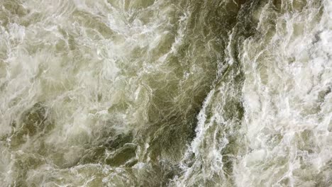 aerial drone top view of the swirling and rushing water texture of the nile river, jinja, uganda