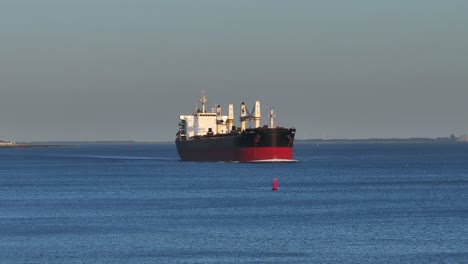 aerial drone view of the tomini unity cargo ship sailing on a river near zouteland in the netherlands