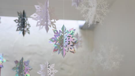 colorful snowflakes twirling against a white backdrop