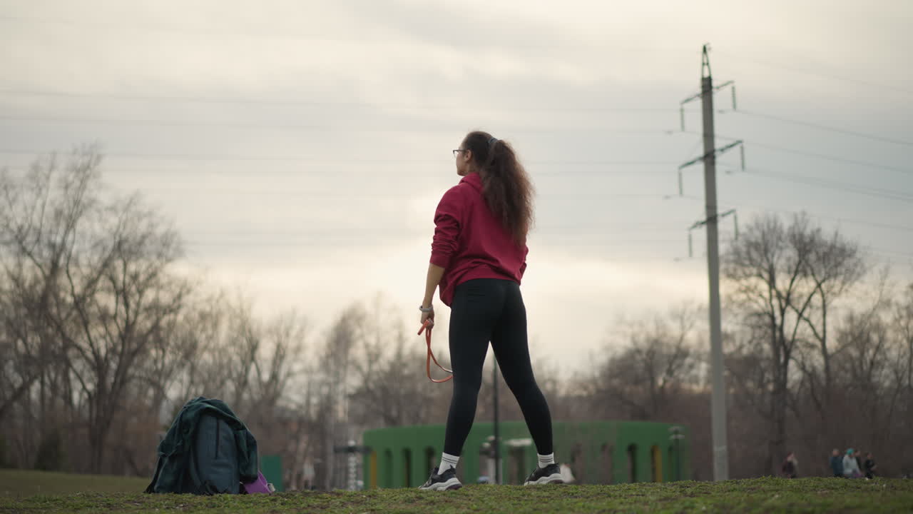 Woman Gestures Outdoors, Woman With Outstretched Arms Standing Alone In Open Landscape At Sunset, Caucasian Female Outdoors During Dusk Gestures With Arms Wide While Surrounded By Natural Elements