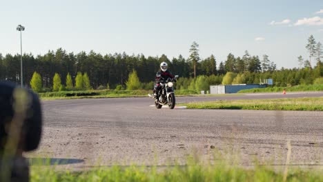 revving up motorcycle with wheelie on racetrack at latvia