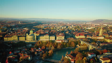 evening view of the swiss parliament building by the river aare during autumn, old city of bern in switzerland