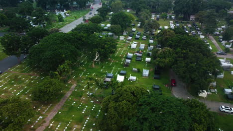 drone shot over graves at the manila memorial park, gloomy day in philippines