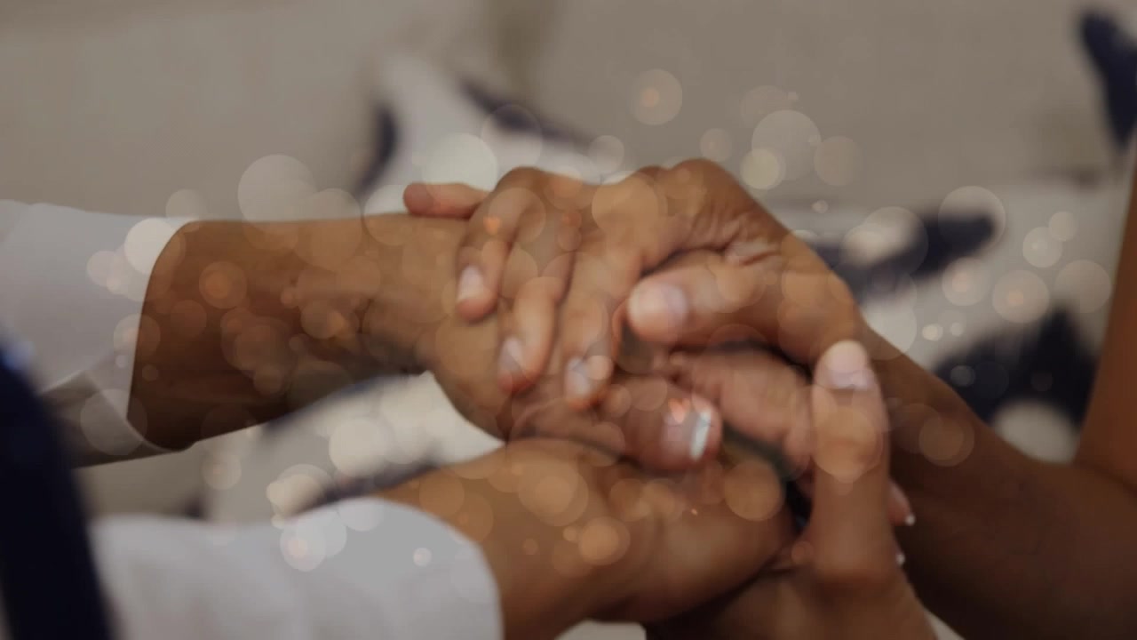 Animation of light spots over holding hands