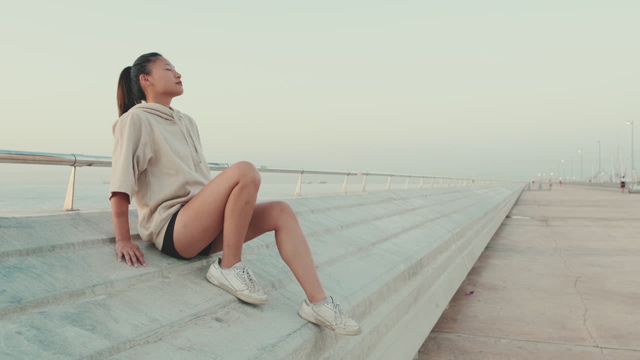 Woman relaxing on stairs at the beach