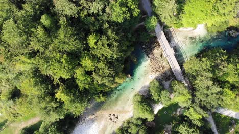 Nice-view-from-above-of-a-turquoise-river-with-footbridge-in-Slovenia