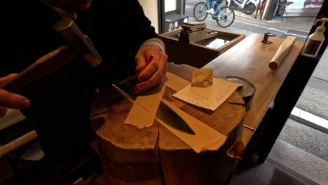 craftsman engraving names on knives in kyoto store