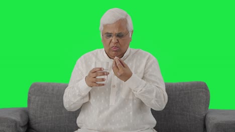 Sick-Indian-old-man-taking-the-medicine-Green-screen