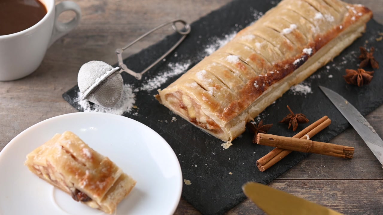 Serving slice of homemade apple strudel