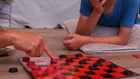 father and son playing board game