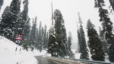 driving on curved road during snowfall in winter