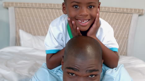 Father-and-son-posing-on-bed