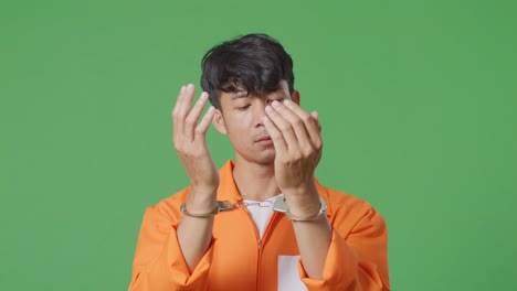 man in orange jumpsuit and handcuffs