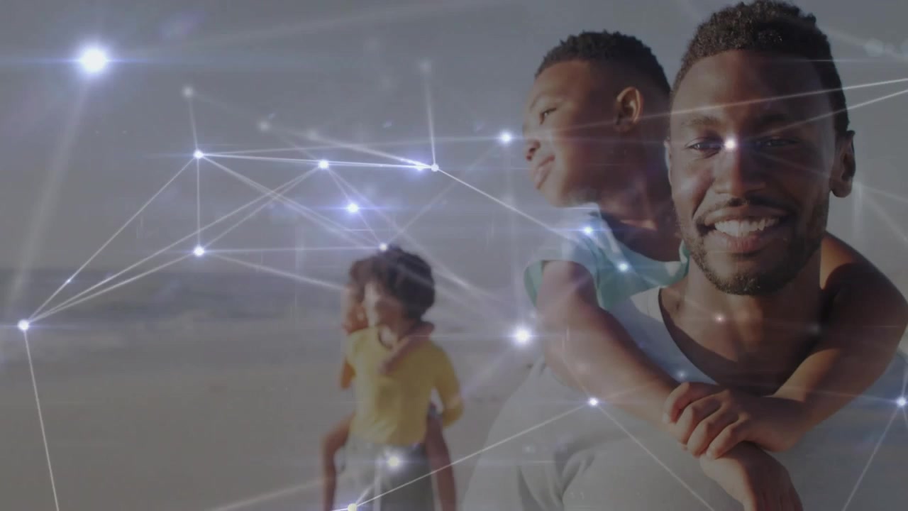 man carrying child on shoulder walking shore, cam shifting as nodes pulse, focusing family for tech