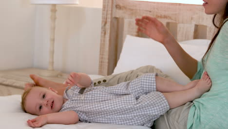 Mother-with-her-baby-boy-on-bed