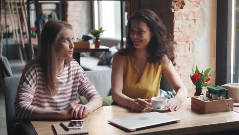 two women having a coffee break in a cafe