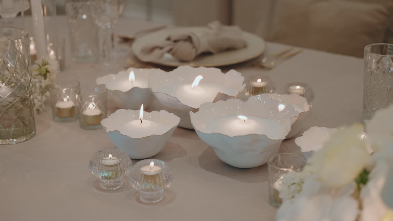 romantic table with white ceramic candles and delicate evening atmosphere