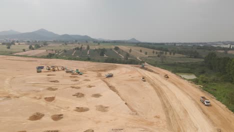 construction site view from above, heavy machinery working on countryside field, thailand