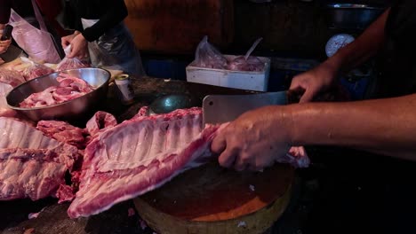 Butcher skillfully cuts and trims pork ribs