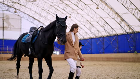mother and daughter horseback riding lesson