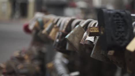 Close-up-slomo-gimbal-shot-of-padlocks-stuck-in-grid