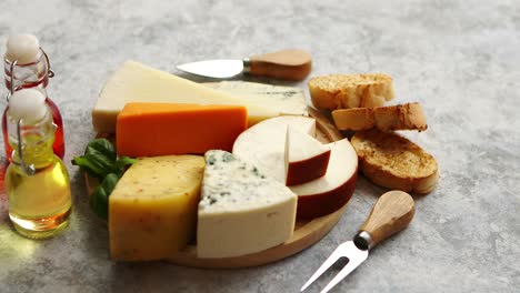 Various-types-of-cheese-served-on-rustic-wooden-board