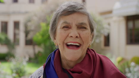 close-up-portrait-of-cheerful-old-woman-laughing-happy-looking-at-camera-wearing-scarf