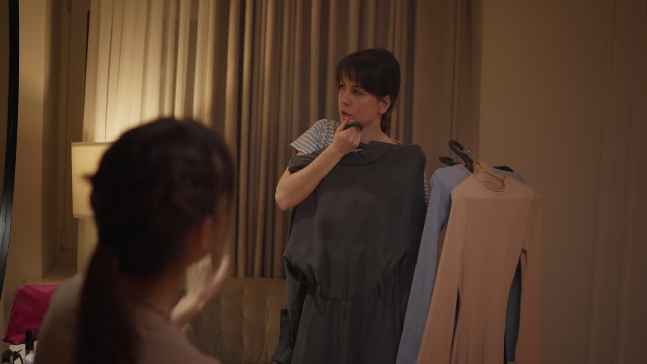 Two women discussing clothing options