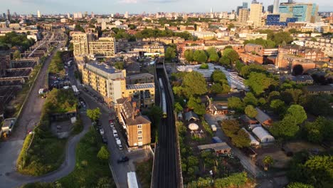 aerial view train travelling on railway through urban city in england