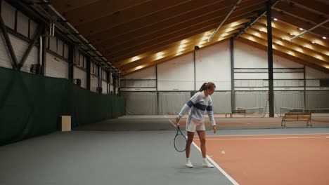 woman playing tennis indoor