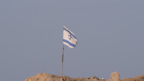 the israeli flag flutters in the wind