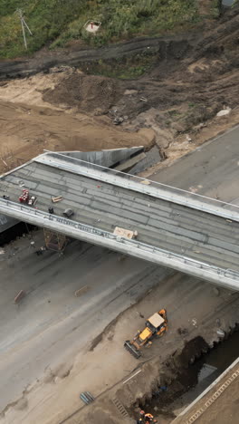 aerial view of bridge under construction with heavy equipment