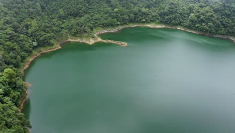 danao lake in leyte, philippines - top view of tranquil green waters of danao lake at summer - aerial drone shot ascending