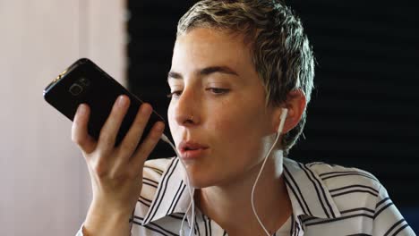 woman talking on mobile phone at cafe 4k