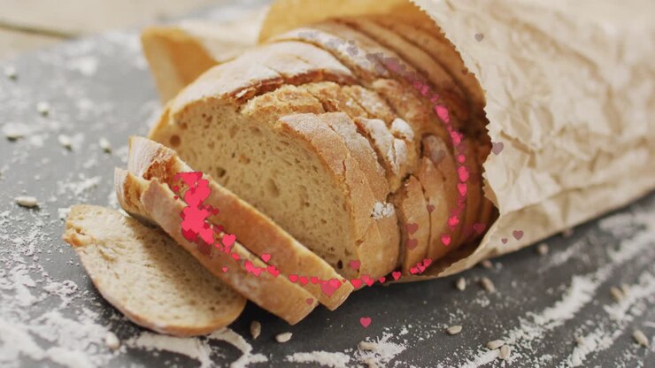 Heart particles entering lower edges, orbiting around rustic loaf, dispersing to highlight bread