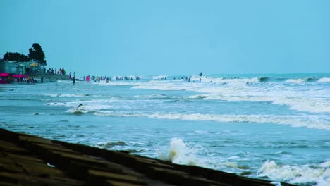 crowd of people at kuakata sea beach in the bay of bengal, bangladesh