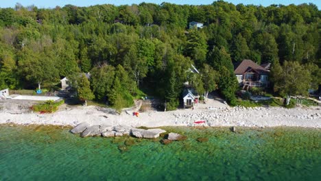 gorgeous turquoise waters in a northern lake lined with luxury summer homes