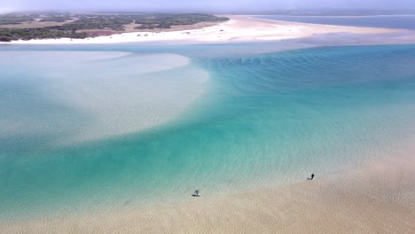 two fly fishermen at the edge of a lagoon that has breached into the ocean