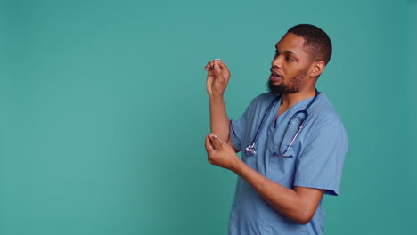 male nurse pointing finger towards empty space doing advertising