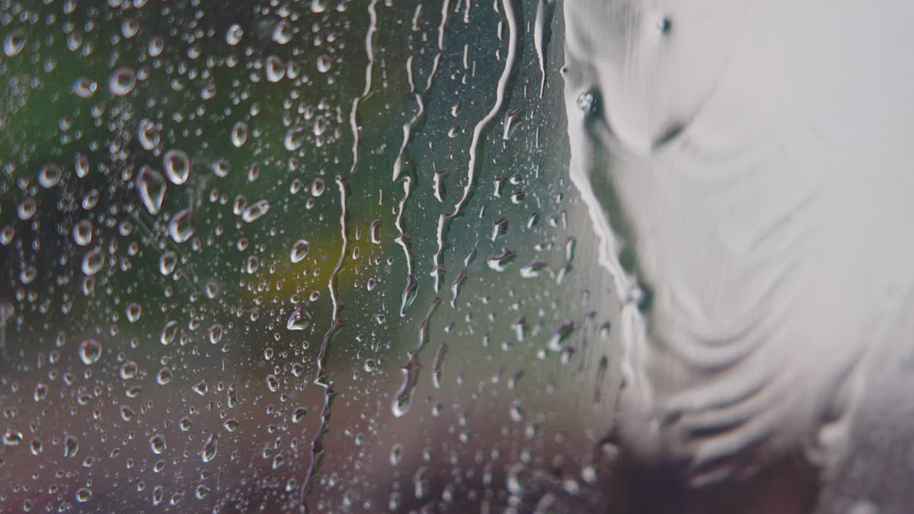 Raindrops Running Down a Window Pane on a Rainy Day