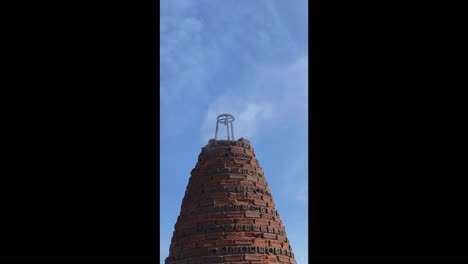 ancient brick tower with smoke