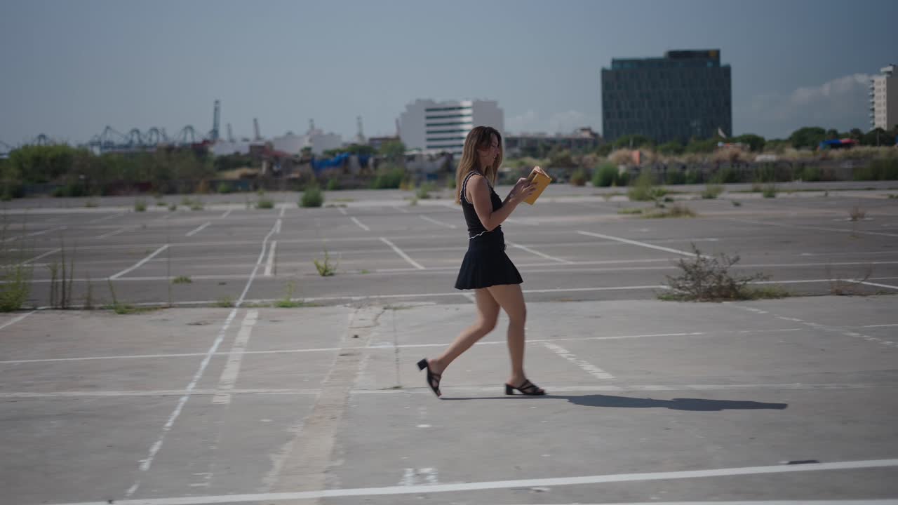 Woman walking in an empty parking lot